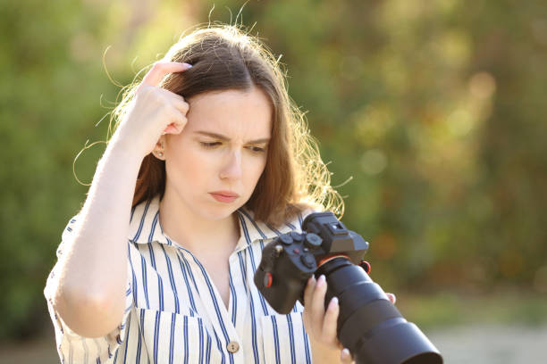 istock Upset photographer checking photos on camera 1481122412