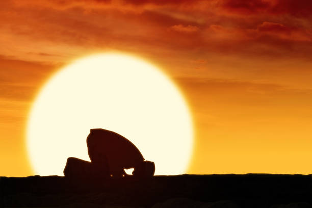 istock muslim man praying with sun background 1481122511
