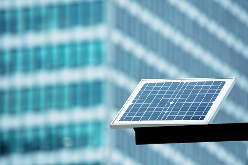 Solar panels in the city to power street lights and signs, sustainable development concept