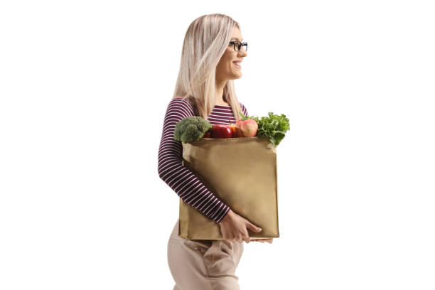 istock Blond woman walking and holding a grocery bag 1481126701