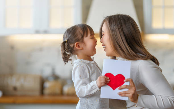 istock Daughter giving mother postcard 1481126951