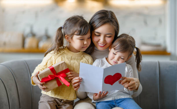 istock Daughters giving mother postcard ang gift 1481126957
