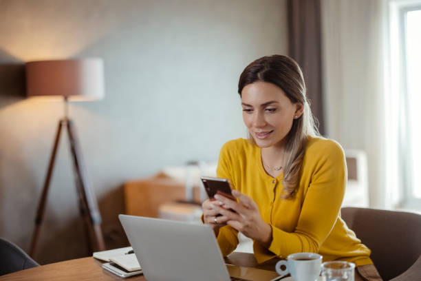 istock Businesswoman Using Smartphone in Hotel Room 1481127004