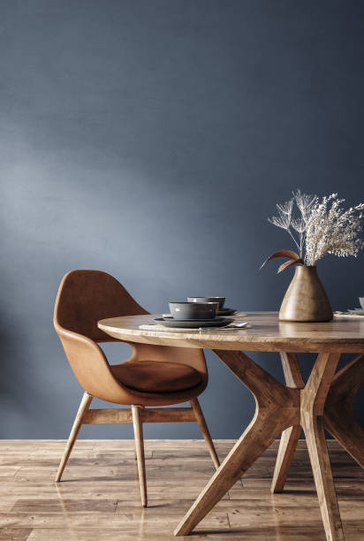 istock Home mockup, modern dark blue dining room interior with brown leather chairs, wooden table and decor 1481127401
