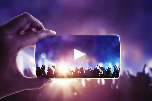 Photo of People hand holding their smart phones and photographing concert