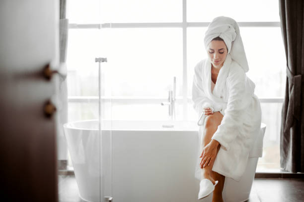 istock Woman in Bathrobe Applying Body Cream 1481129430
