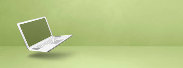 istock Floating computer laptop isolated on green. Horizontal banner background 1481131003