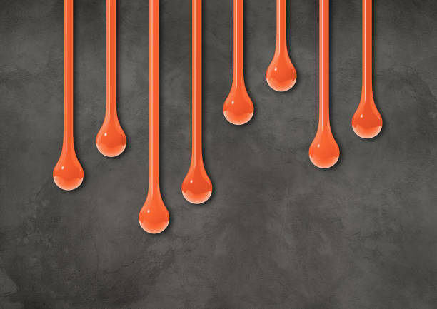 istock Orange ink drops on dark concrete wall. Horizontal wallpaper 1481131176