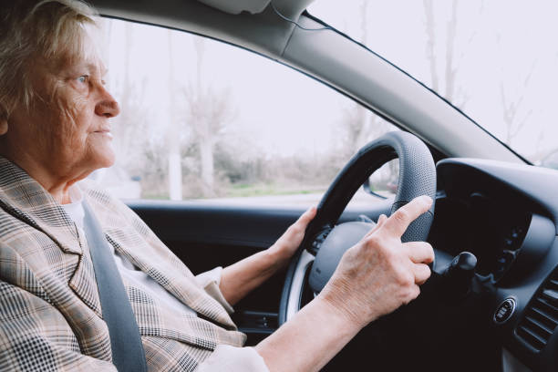 istock Smiling old woman sitting inside the car 1481135168