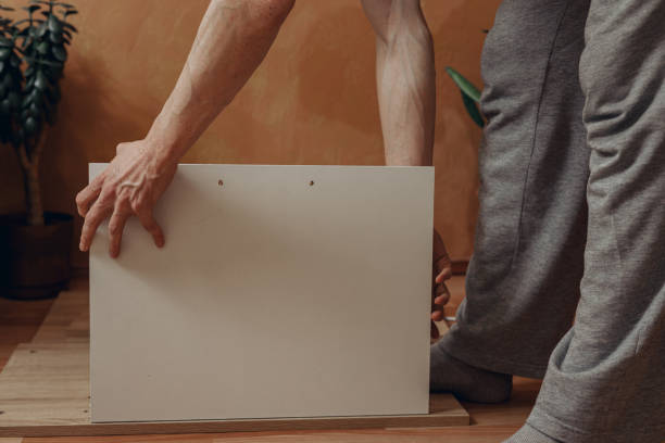 istock Man assembling wooden cabinet at home 1481136452