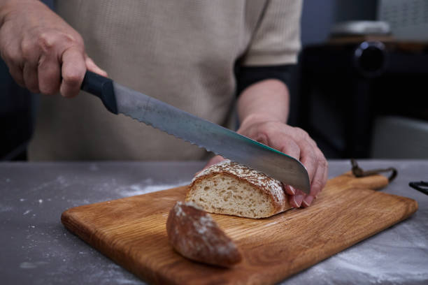 istock woman slicing whole wheat bread 1481137856