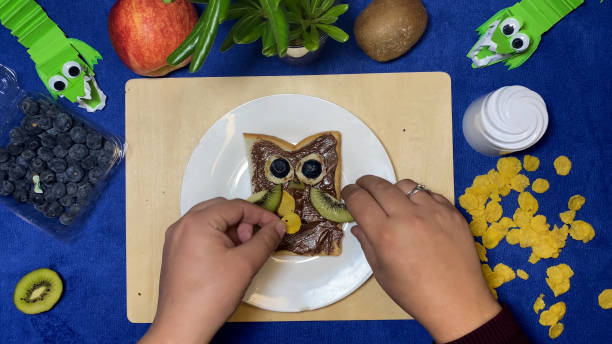 istock Kids creative breakfast. Nutella spread with fruits in the owl shape 1481138982