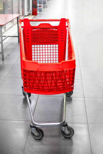 istock empty red cart for groceries in the mall. vertical 1481139406