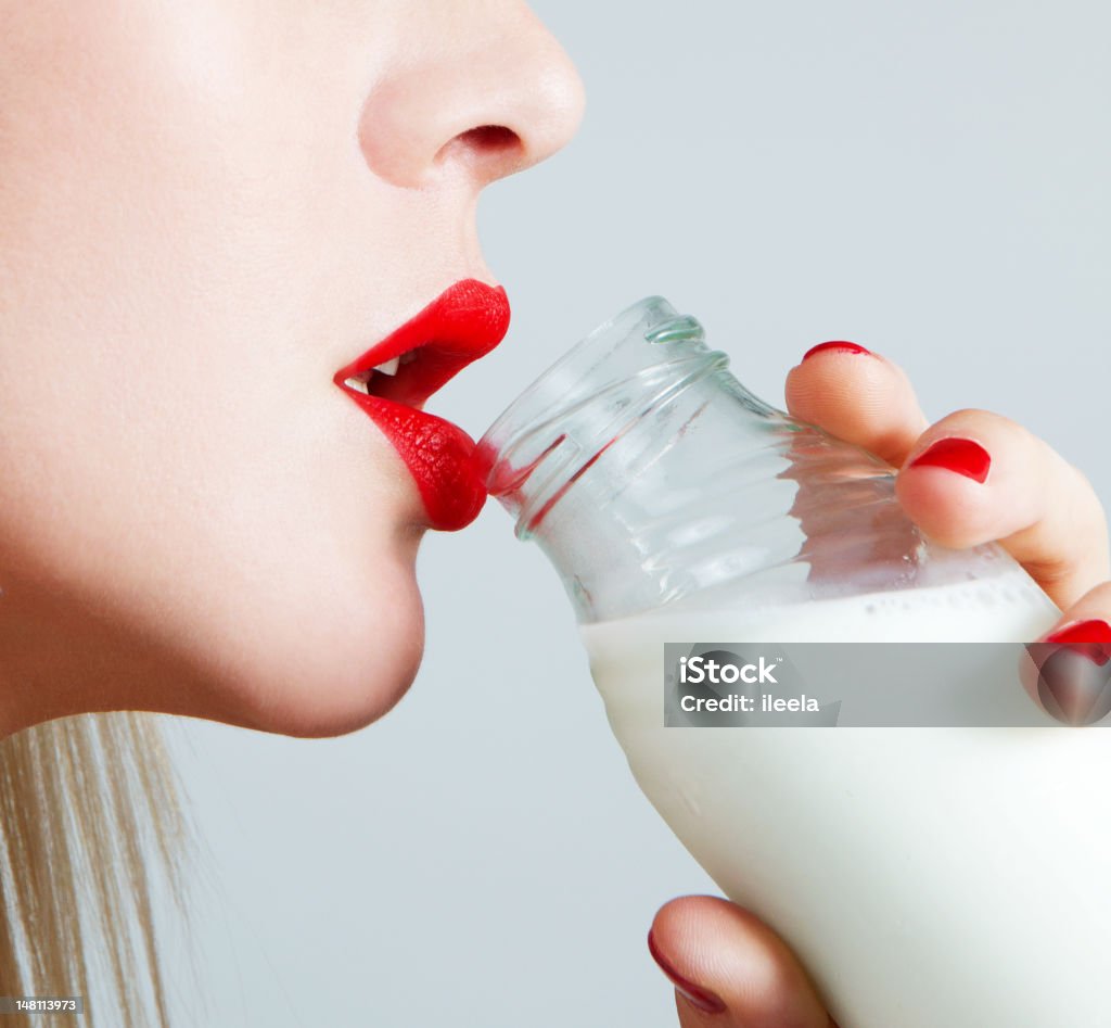 milk and lips close up of milk bottle and red lips Drinking Stock Photo