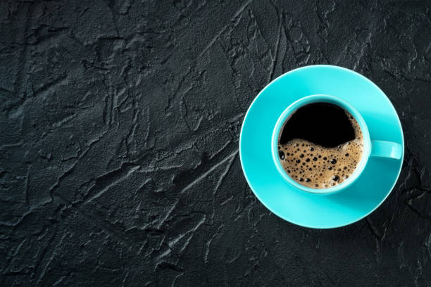 istock Coffee cup, shot from the top on a black stone background with copy space 1481143303