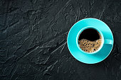 istock Coffee cup, shot from the top on a black stone background with copy space 1481143303