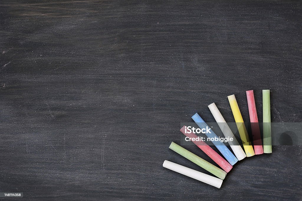 Colorful chalk on a blank smudged blackboard Blank smudged blackboard background with colorful chalk for text writing and design Backgrounds Stock Photo