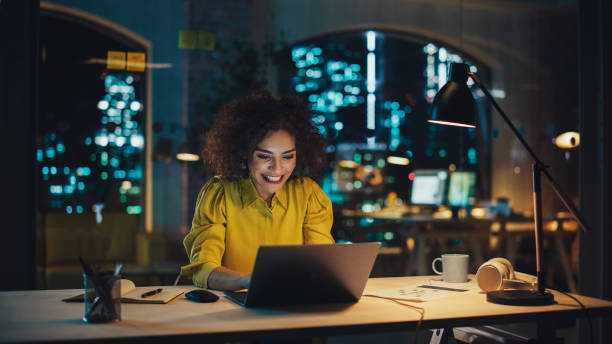 istock Expressive Multiethnic Middle Eastern Female Working on a Creative Job Position in an Advertising Company. Manager Brainstorming Ideas, Excited for the Selection of her Project. Office at Night. 1481145813