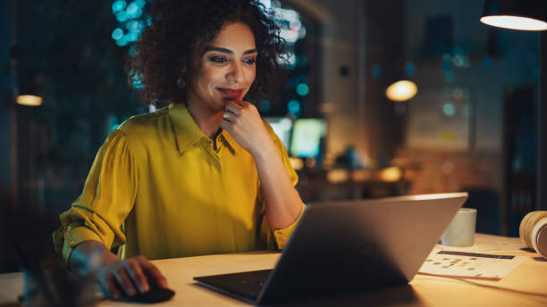 istock Expressive Multiethnic Middle Eastern Female Working on a Creative Job Position in an Advertising Company. Manager Thinking About a Good Email Reply, Brainstorming Ideas. Office at Night. 1481145849