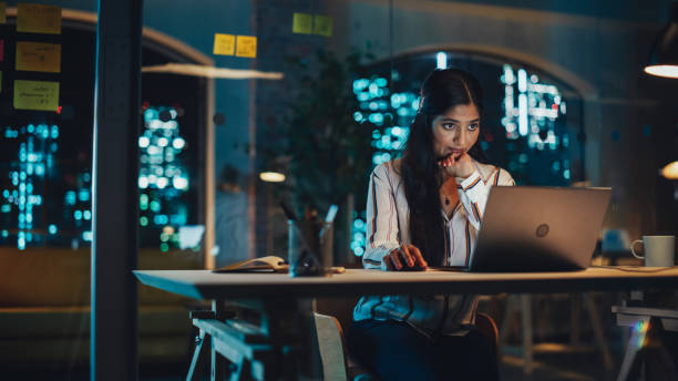 istock Indian Female Working in Creative Agency, Implementing Modern Business Strategy for Clients. Successful Specialist Using Laptop Computer at Night in the Office. 1481145897