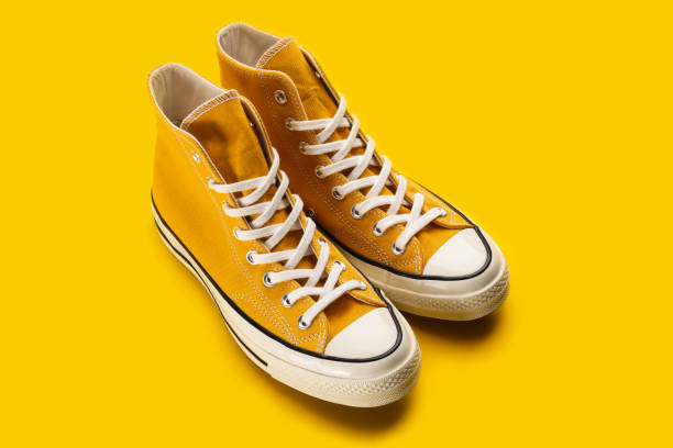 istock Yellow sneakers on white background with copy space. Youth shoes. 1481146145