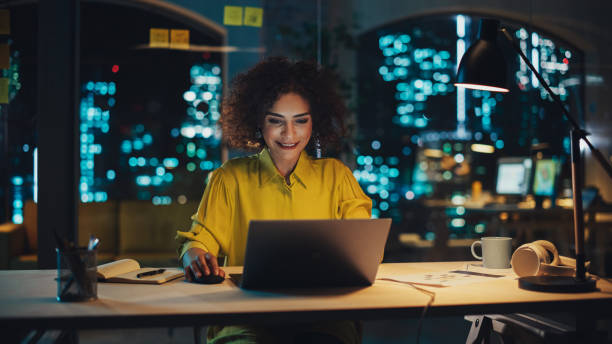 istock Multiethnic Female Working in Creative Agency, Implementing Modern Business Strategy for Clients. Successful Specialist Using Laptop Computer at Night in the Office. 1481146199