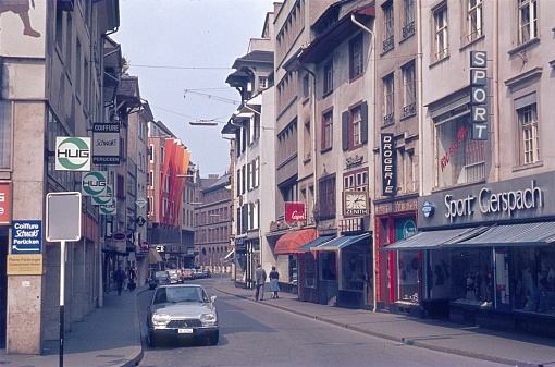 Basel, Switzerland, 1976. Street scene with pedestrians, shops and buildings in Basel.