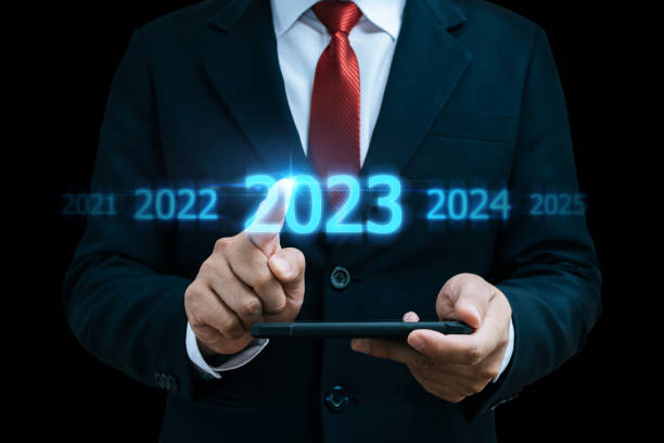 istock 2023. businessman hand touching and pointing on year 2023 with virtual screen on dark background, goal target, change from 2022 to 2023, strategy, investment, business planning, happy new year concept 1481147451
