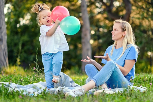 Portrait of mother and daughter hugging in the park