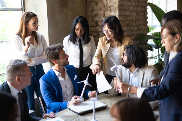 istock Group of multiethnic people working at sustainability project about renewable energy and green power. 1481148609