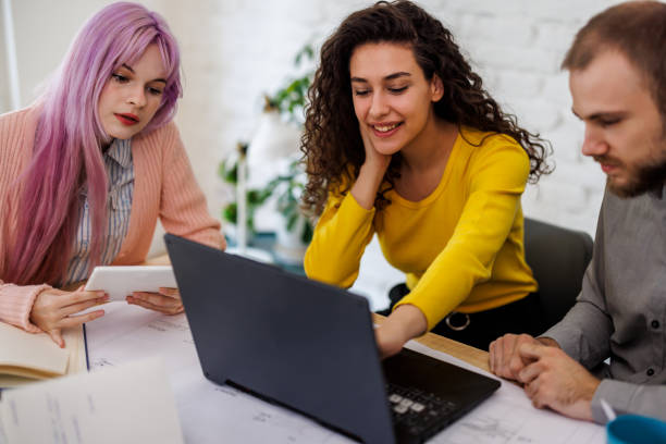 istock A group of young friends is studying at home using a laptop. 1481151403