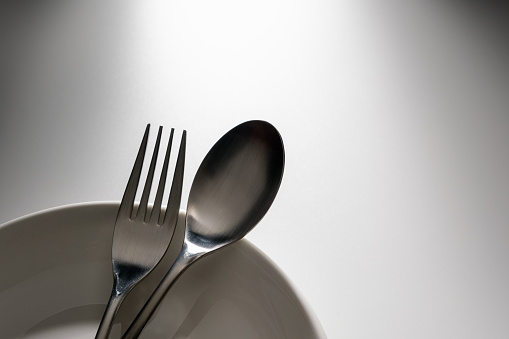 Fork and spoon on white background