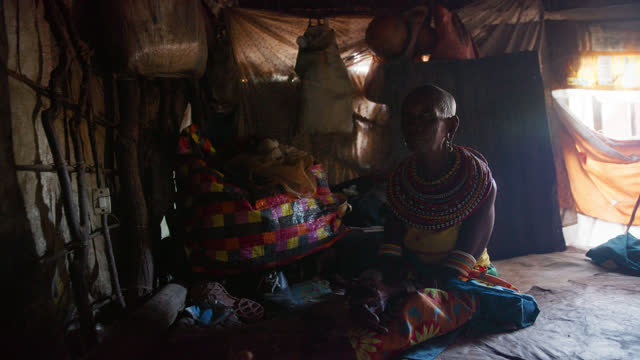 SLO MO Elderly woman inside of her tribal hut - Samburu Tribe. Documentary footage