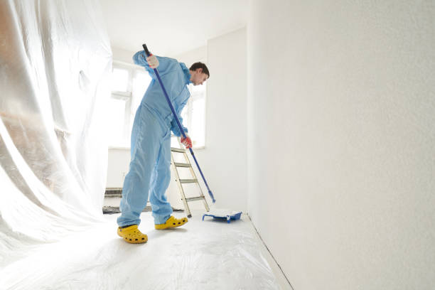 istock Man dipping a roller into a palette of paint. 1481154424
