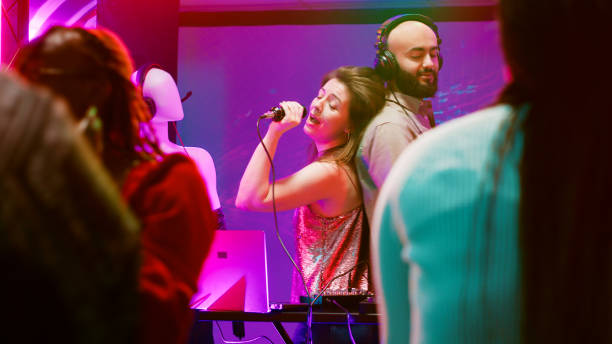 istock Young woman singing songs with DJ 1481154643