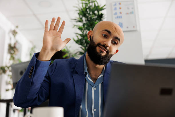 istock Arab businessman greeting clients online during videocall from office 1481155933
