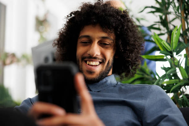 istock Businessman browsing internet on smartphone while relaxing in office 1481158364