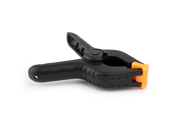 istock Spring clamp isolated on white background. Black plastic clamp. Set of small and big size. Clamping equipment for handicraft, joinery, photography, cars. 1481158485