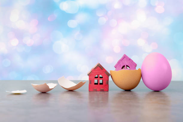 istock Tiny houses in eggs shell against abstract holiday background with copy space. Conceptual Easter greeting card 1481160196