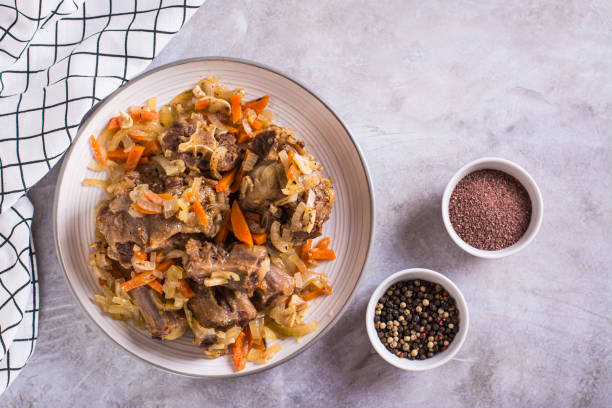 istock Stewed oxtail with carrots and onions on a plate on the table top view 1481160434