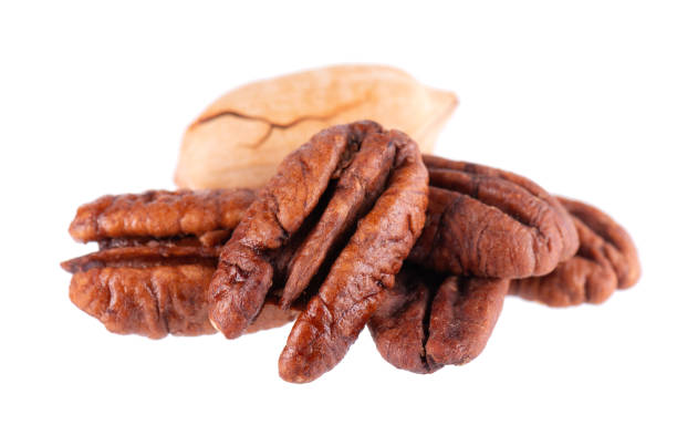 istock Pecan nuts isolated on white background. Shelled and unshelled pecan. Clipping path. 1481162055