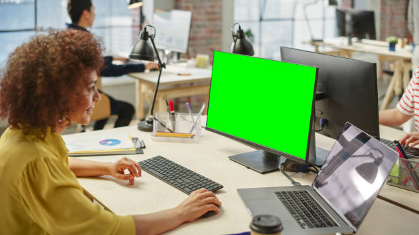 istock High Angle View of a Female Worker Using Computer in a Bright Modern Office. Administrator Smiling and Preparing a Presentation Using Green Screen. Statistics and Charts are on Display on the Laptop. 1481163825