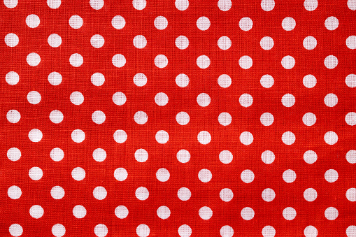 Red and white polka dot cotton texture. Fabric textile background