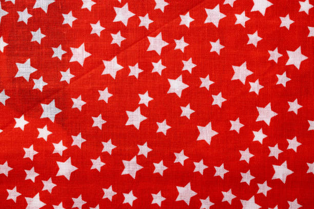 Red cotton texture with white stars. Fabric textile background
