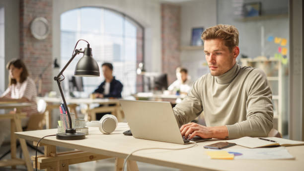 istock Portrait of Caucasian Man Focused on Work While Using Laptop in a Modern Spacious Office. Male Budget Analyst Reviewing and Developing Crisis Management Plan. 1481165186