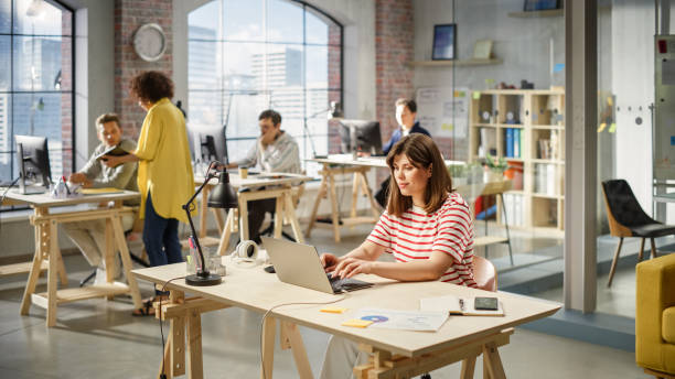 istock Portrait of Young Female Executive Assistant Working on Scheduling Meetings. Statistics and Charts are on Display on Papers. 1481165647
