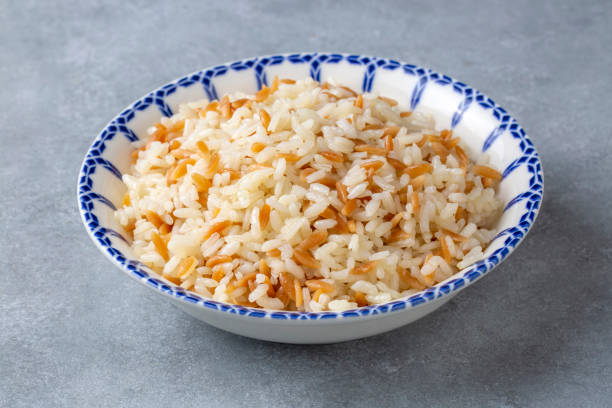 Traditional delicious Turkish food; Turkish style rice pilaf (Turkish name; Arpa sehriyeli pirinc pilavi) Traditional delicious Turkish food; Turkish style rice pilaf (Turkish name; Arpa sehriyeli pirinc pilavi) ARPA stock pictures, royalty-free photos & images