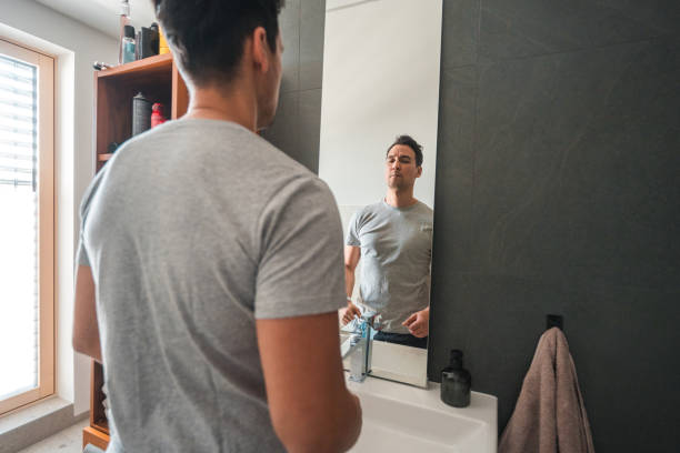 istock Handsome Mid Adult Biracial Man Looking in a Mirror 1481168526