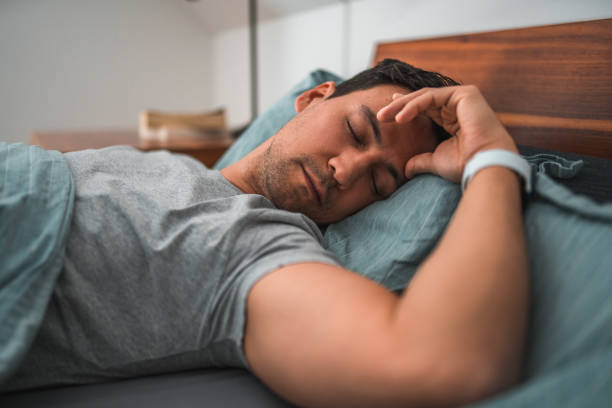 istock Handsome Man Sleeping in Bed Wearing a Wrist Watch 1481168532
