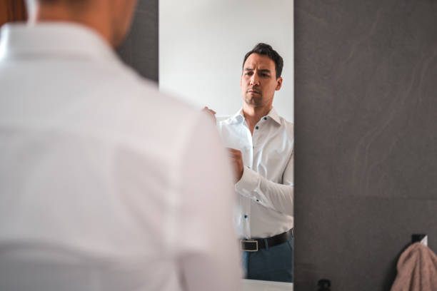 istock Handsome Biracial Mid Adult Man Getting Dressed for Work 1481168535